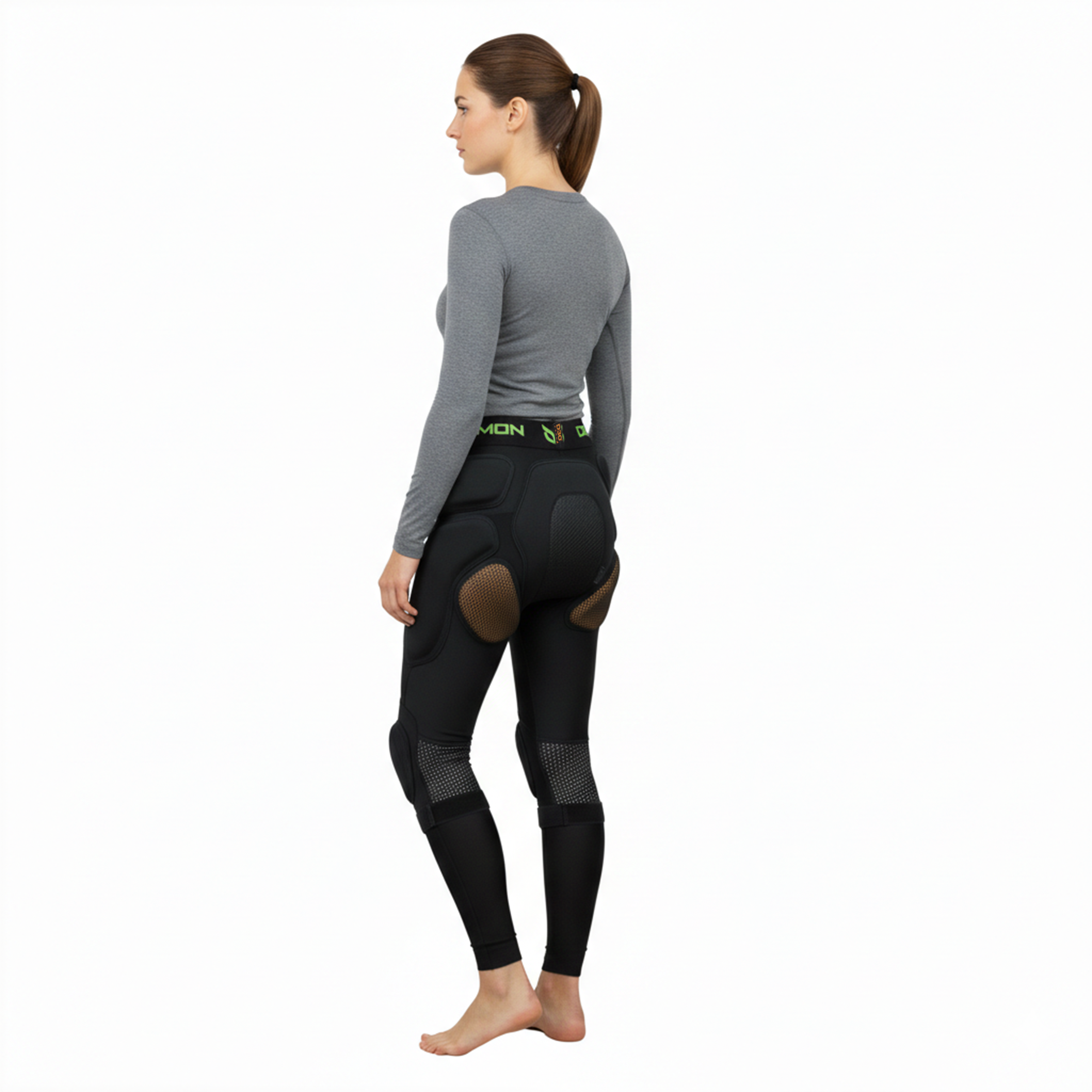 Person wearing black compression pants with visible branding on a white background