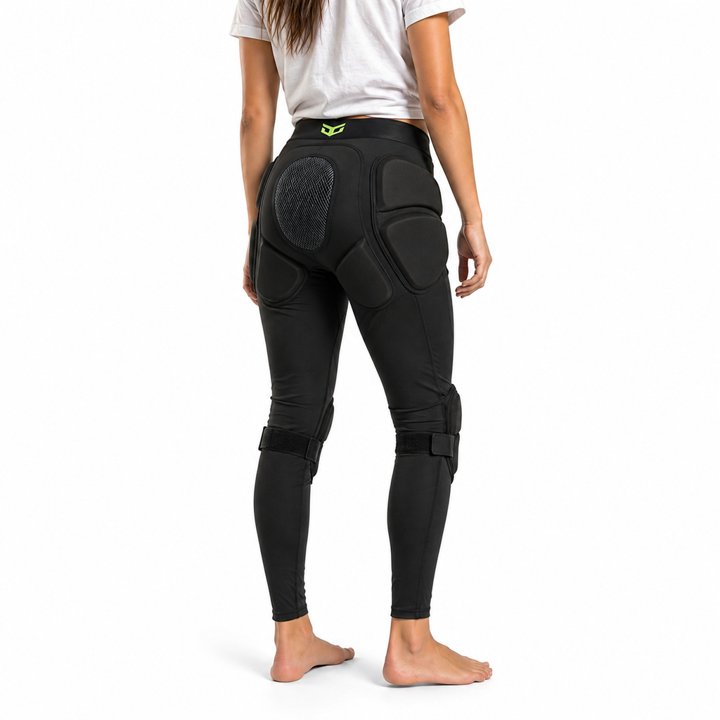 Person wearing black protective pants with knee pads on a white background