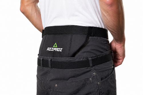 Person wearing black pants with a visible brand logo on a white background