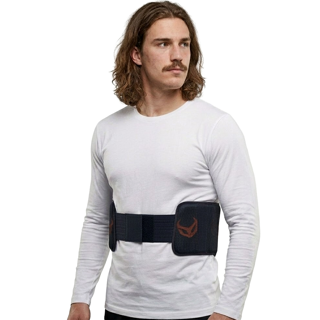Man wearing a white long-sleeve shirt with a black belt featuring a logo on a white background