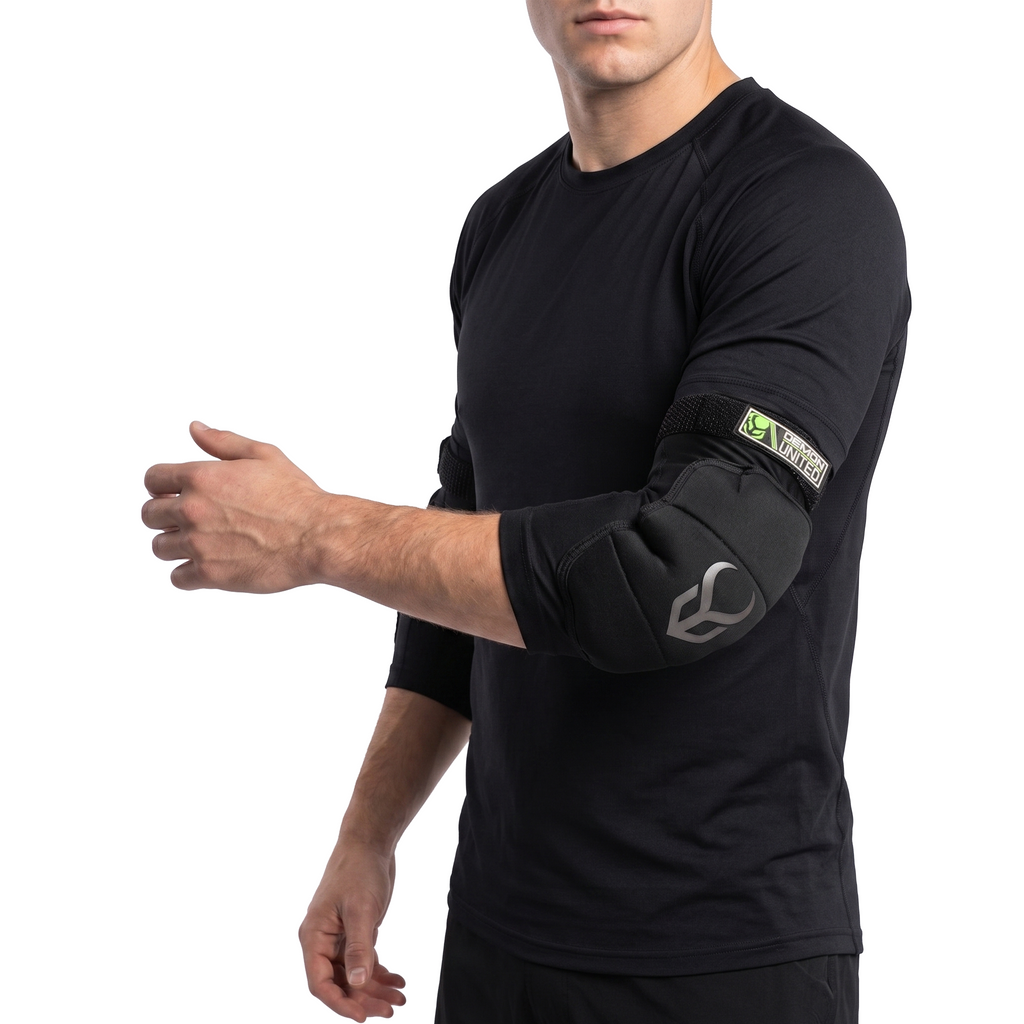Person wearing a black long-sleeve shirt with elbow pads on a white background