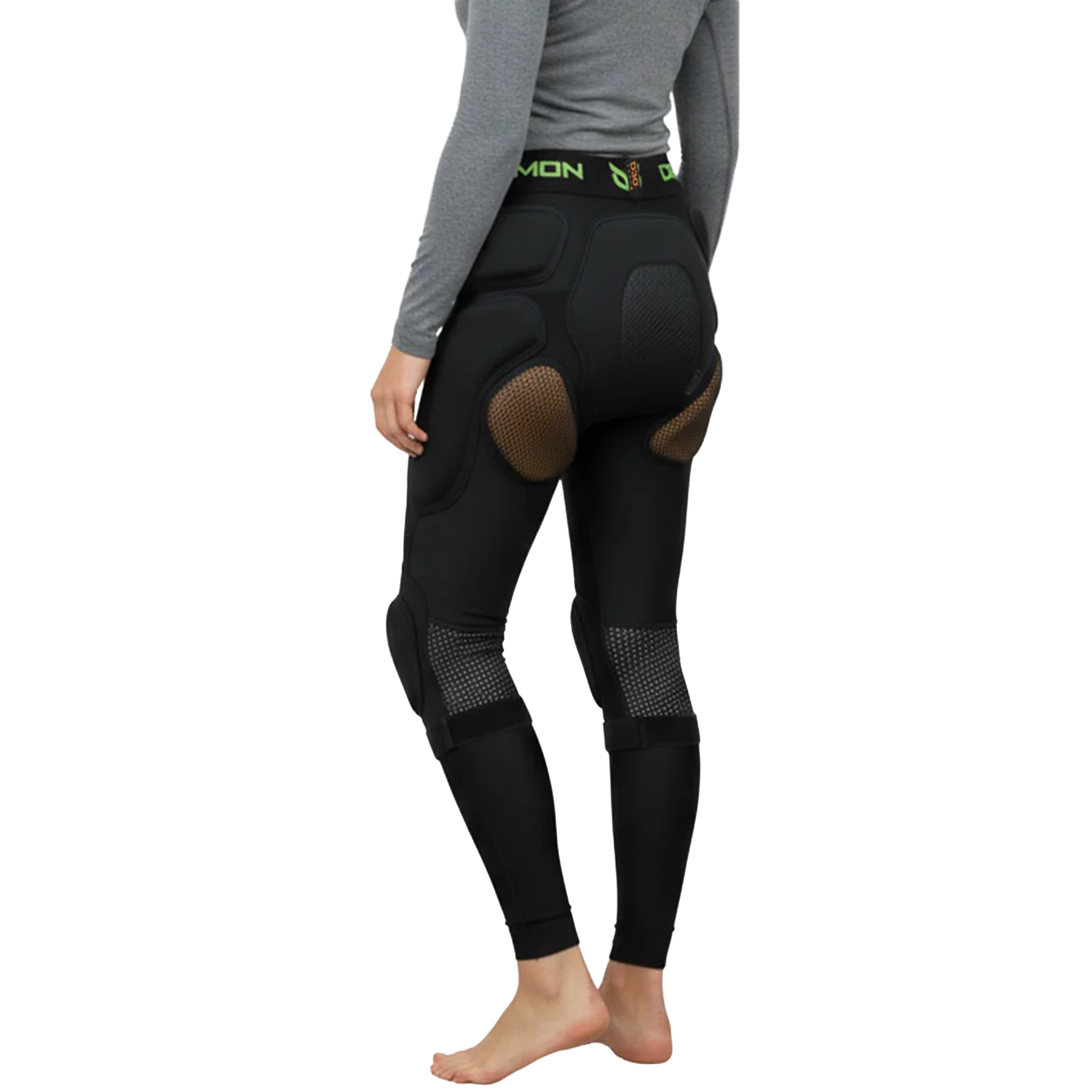 Person wearing black protective riding pants with a white background