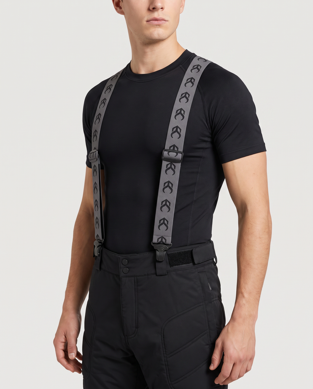 Model wearing Demon Snow Suspenders clipped to padded snowboard shorts