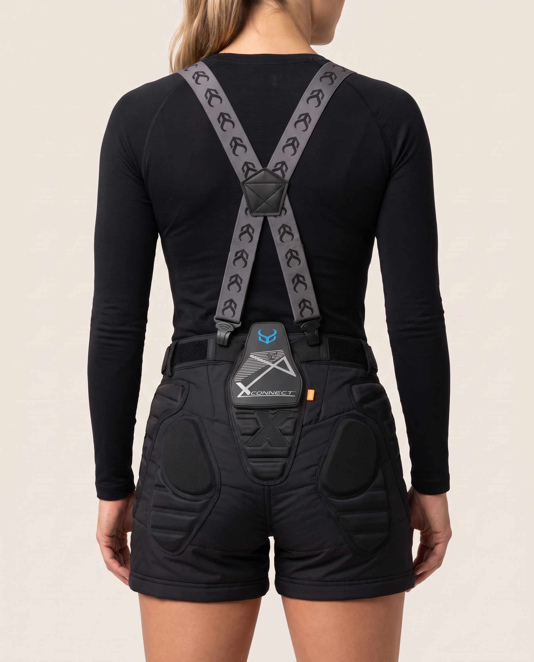 Female model, back view, wearing Demon Snow Suspenders over V7 women's padded shorts