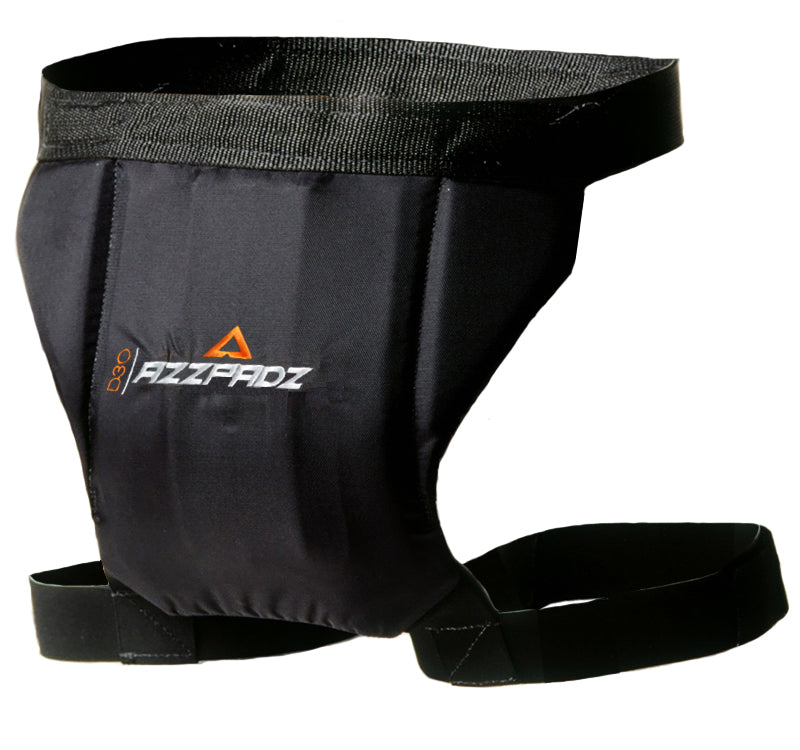 A black Demon AZZPADZ D3O tailbone protector with adjustable straps and a visible logo.