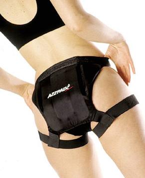 Black strap-on tailbone protector with multi-layered cushion and adjustable leg straps on a female model.