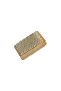 A large base brush with white nylon bristles on a beige handle, designed for applying wax to a snowboard.
